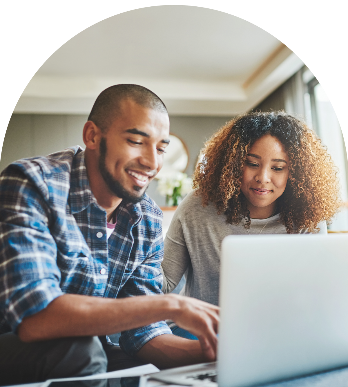 Couple looking at laptop and smiling