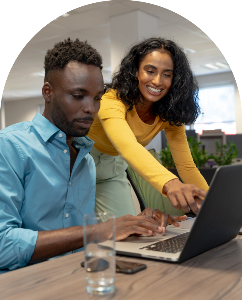 woman helping man with laptop