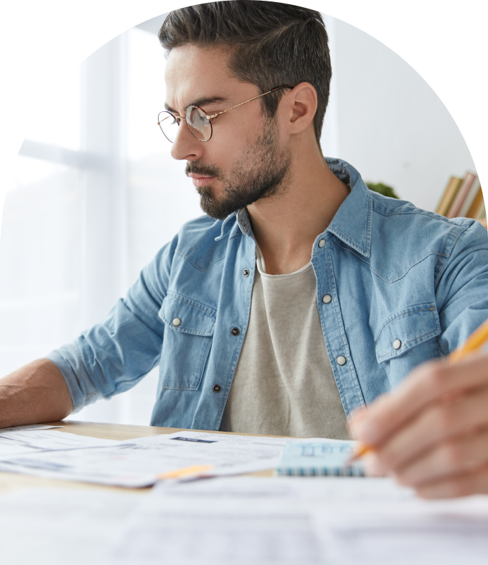 gentleman with glasses working on taxes