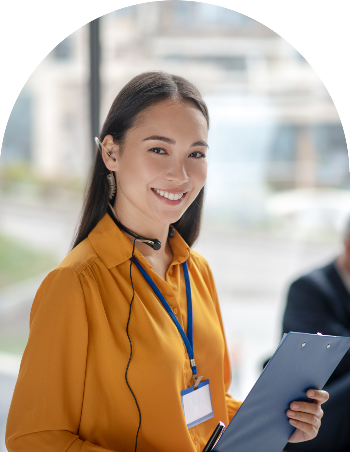 smiling woman with headset and clipboard